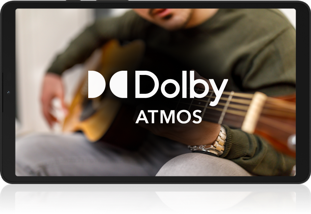 a person holding a guitar & the logo of Dolby Atmos showcasing the rich sound of the device. 