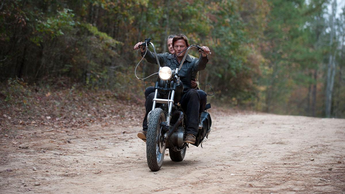 Daryl and Carol riding his motorcyle in The Walking Dead.