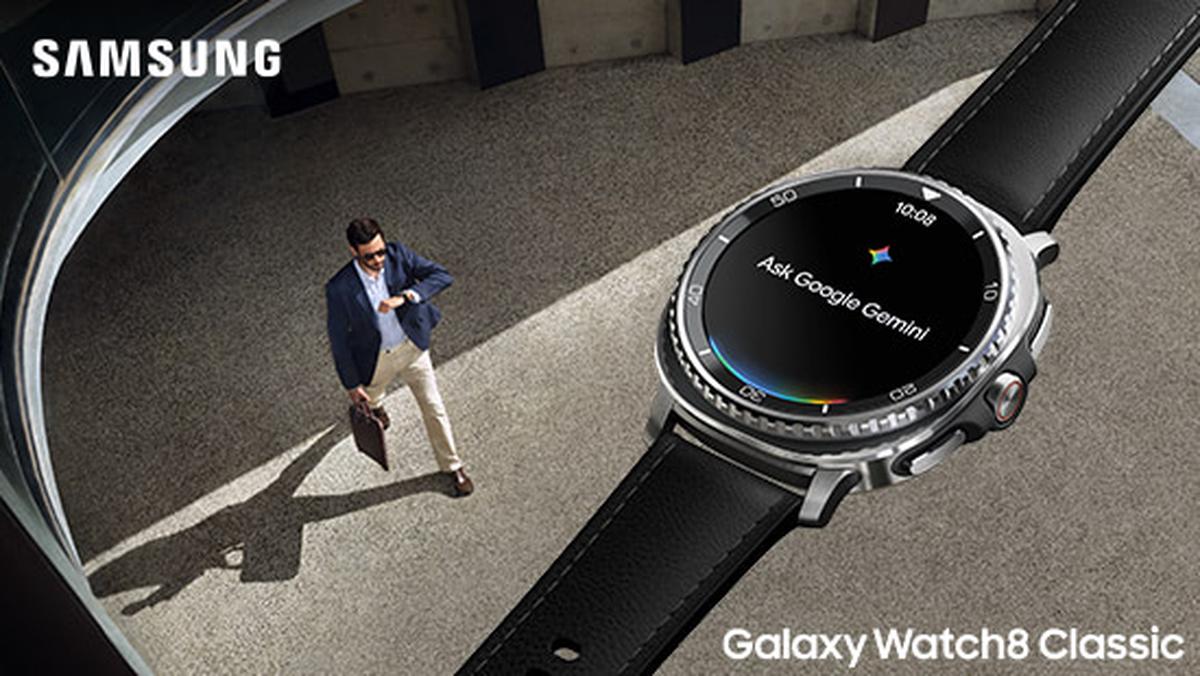 Samsung Galaxy Watch8 Classic with a black leather strap displayed, featuring "Ask Google Gemini" on the screen. A man walks below.