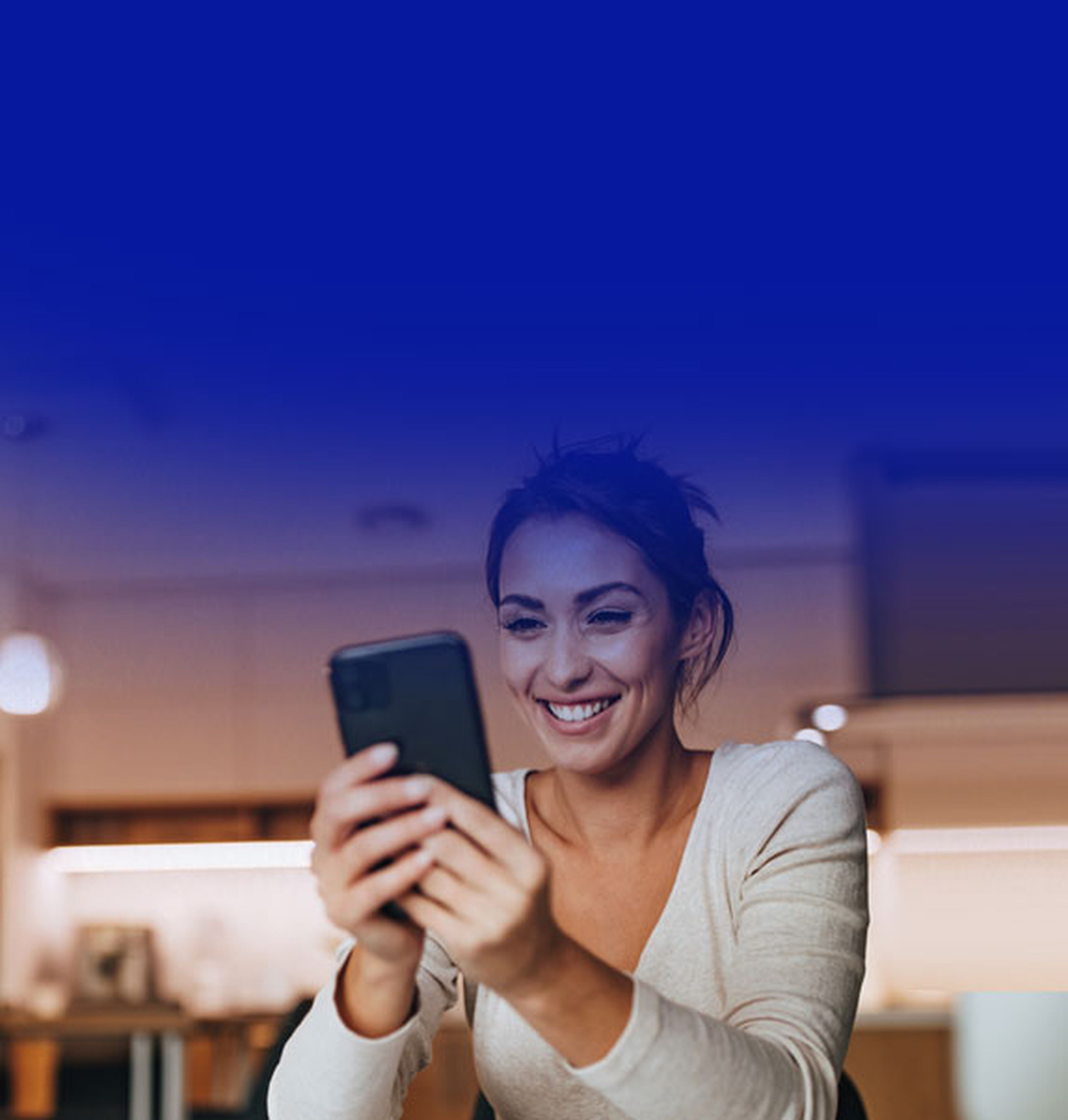 Lady looking at phone and smiling