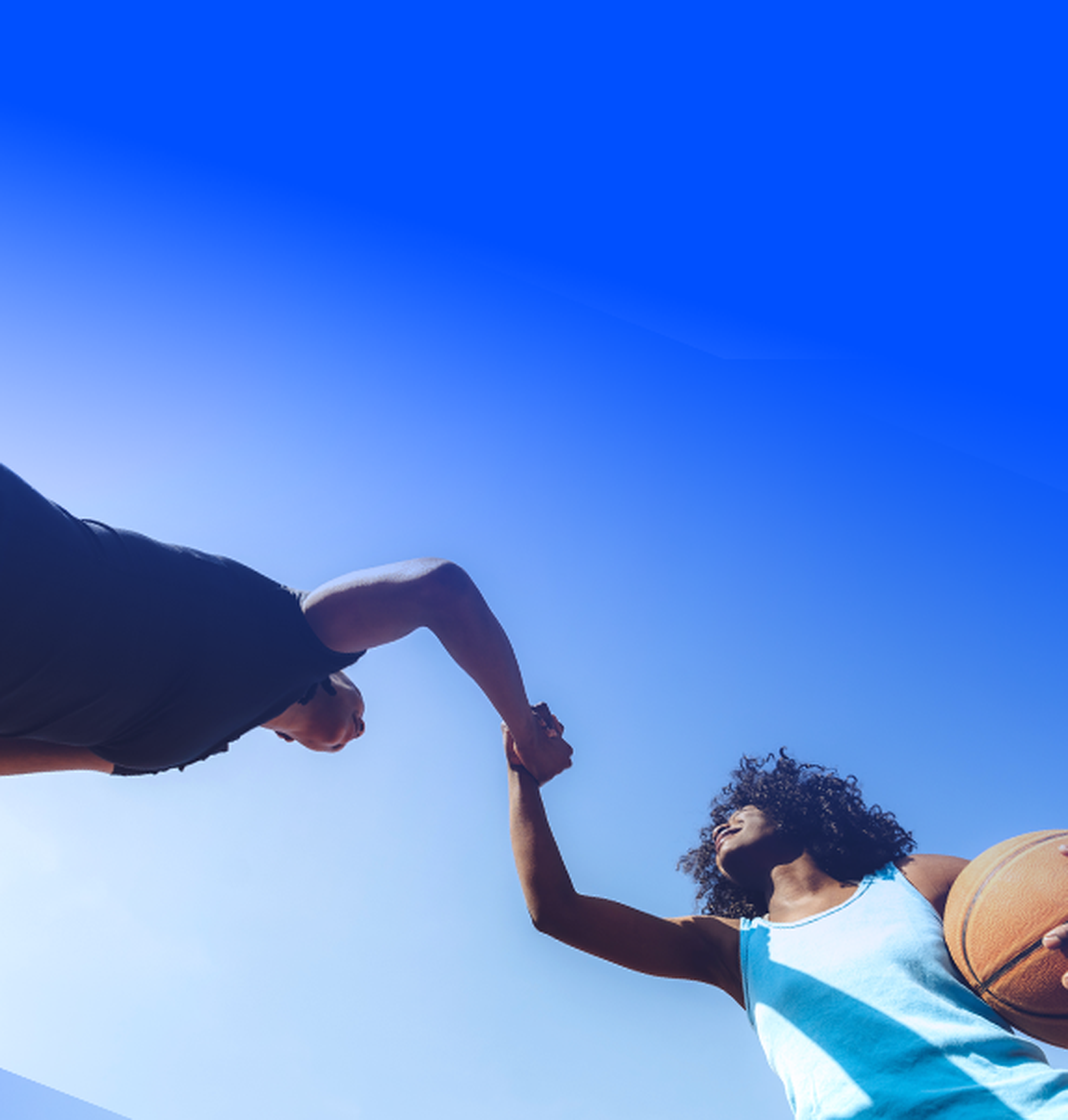 Two women shaking hands before a basketball game