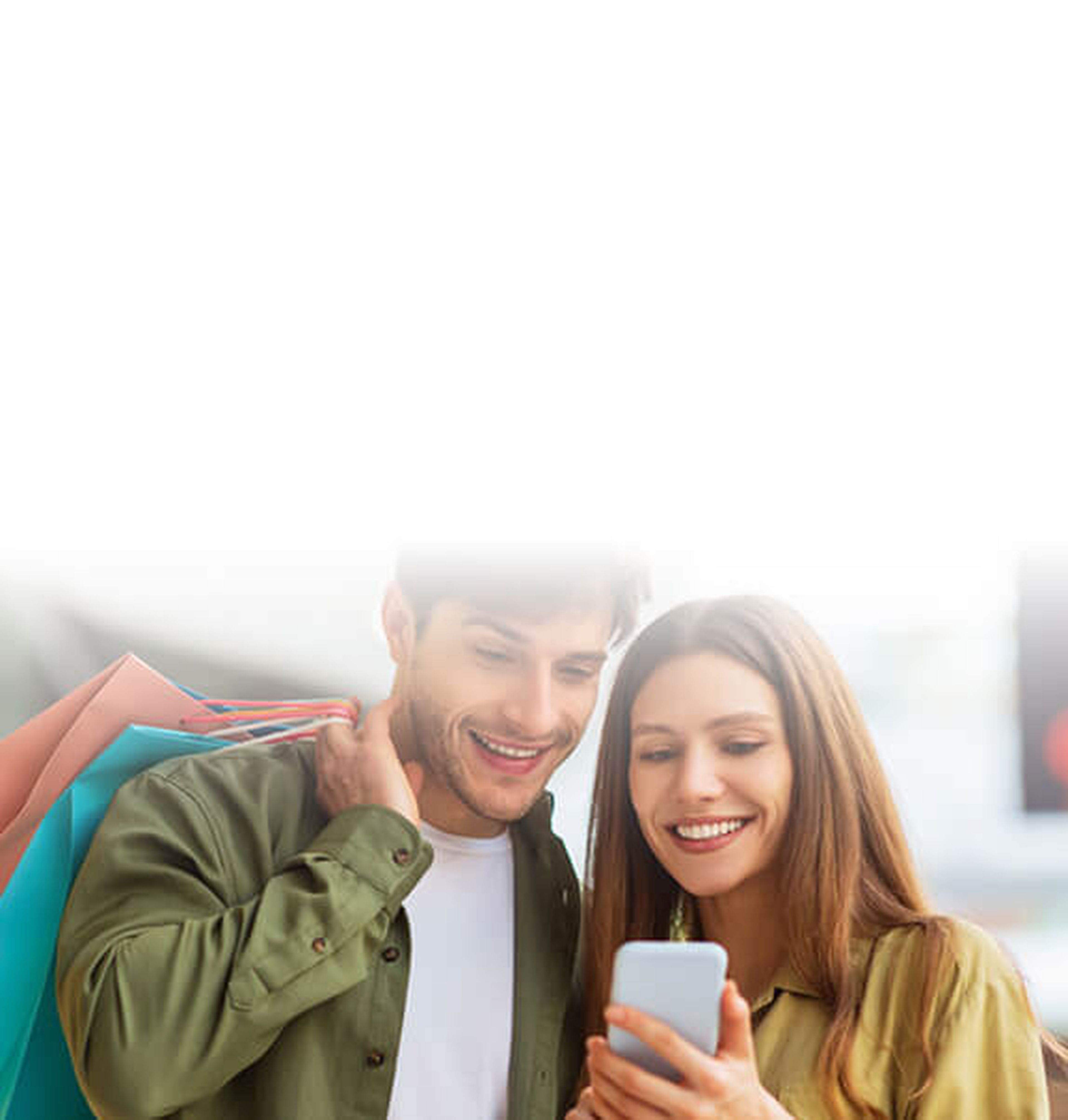 A smiling couple holding a smartphone