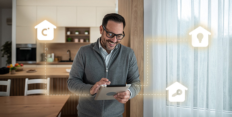 Man using a tablet in a modern kitchen with smart home icons and glowing connections in the air.