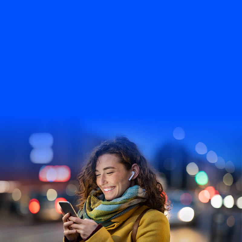Woman laughing and texting on a mobile phone