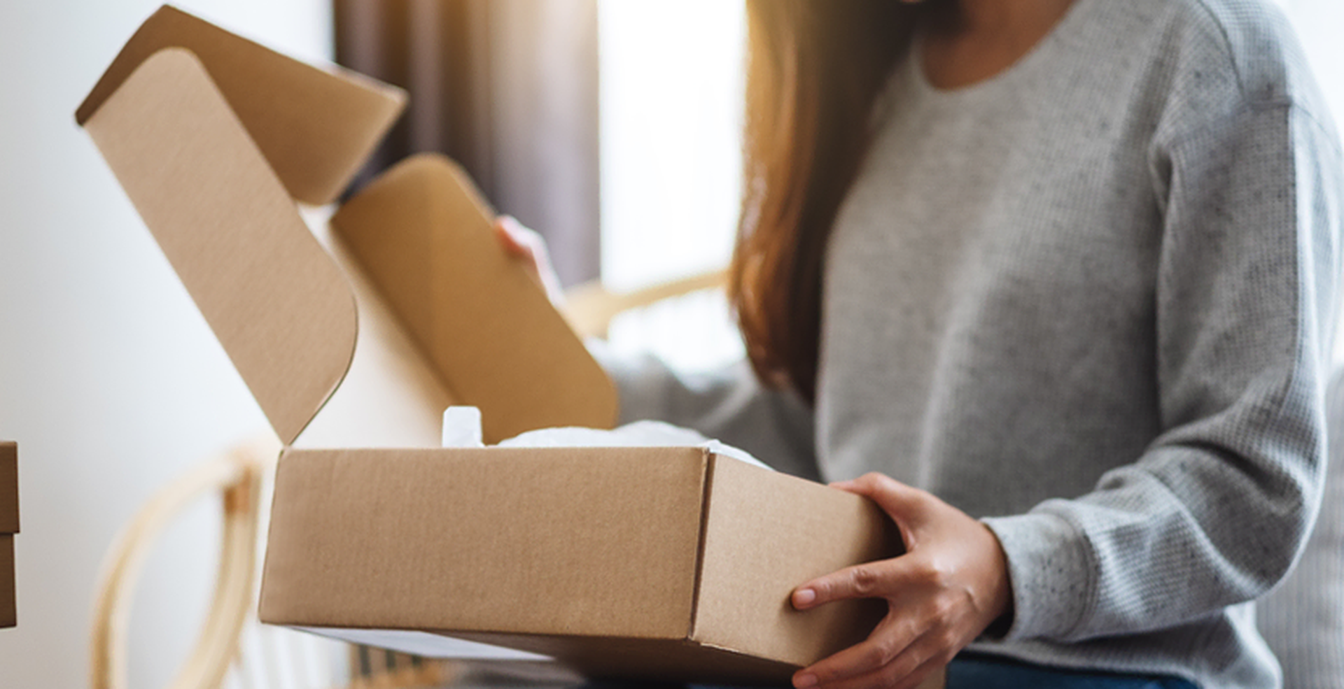 Lady opening cardboard box