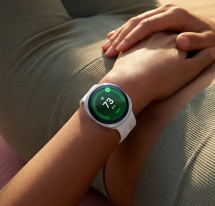 A person laying on a yoga mat hands resting on their stomach with the Watch9 on their wrist showing their heart rate